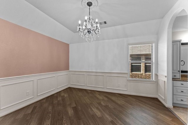 1038 Bolivar Point Ln, Friendswood, TX 77546 - unfurnished dining area with arched walkways, a chandelier, dark wood-style flooring, a wainscoted wall, and a decorative wall