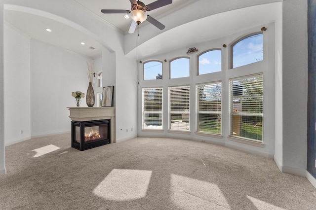 1038 Bolivar Point Ln, Friendswood, TX 77546 - unfurnished living room with carpet flooring, a multi sided fireplace, plenty of natural light, ceiling fan, and crown molding