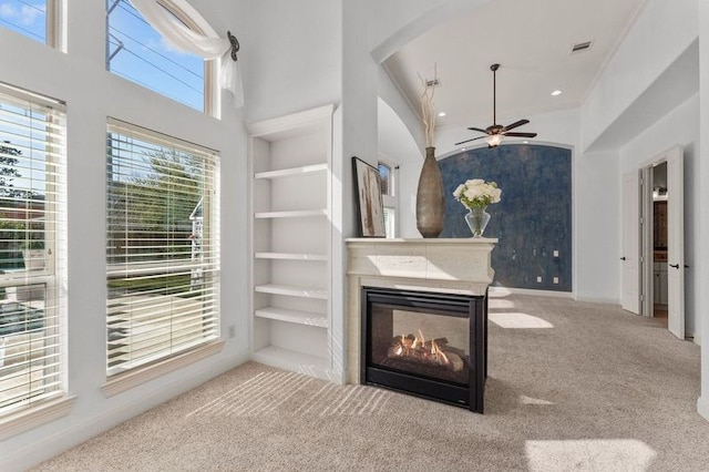 1038 Bolivar Point Ln, Friendswood, TX 77546 - living room featuring a ceiling fan, a multi sided fireplace, carpet floors, baseboards, and built in features