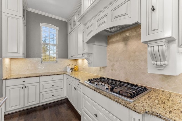 1038 Bolivar Point Ln, Friendswood, TX 77546 - kitchen featuring stainless steel gas cooktop, white cabinets, decorative backsplash, and crown molding