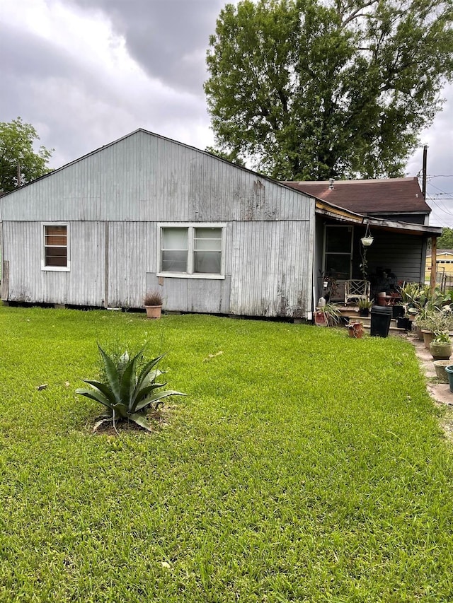 view of property exterior with a yard
