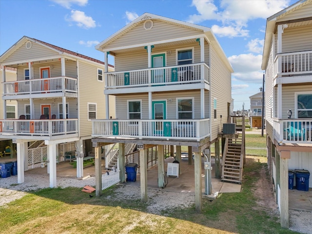 127 Howard, Surfside Beach, TX 77541 - rear view of house featuring a carport, stairway, and central air condition unit