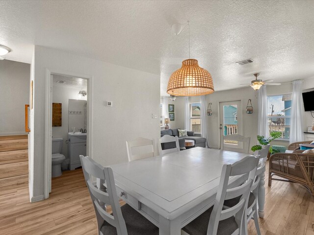 127 Howard, Surfside Beach, TX 77541 - dining area with a textured ceiling, ceiling fan, visible vents, and light wood-style floors