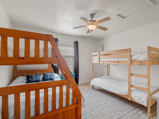 127 Howard, Surfside Beach, TX 77541 - bedroom featuring a ceiling fan, baseboards, attic access, and a textured ceiling