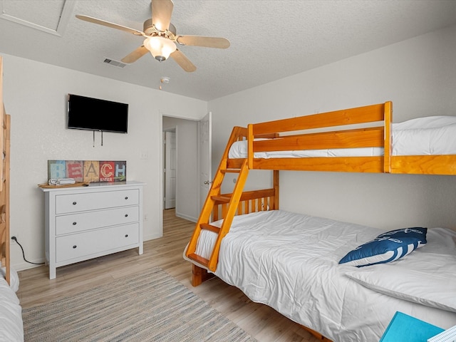 127 Howard, Surfside Beach, TX 77541 - bedroom featuring a textured ceiling, visible vents, ceiling fan, and light wood finished floors