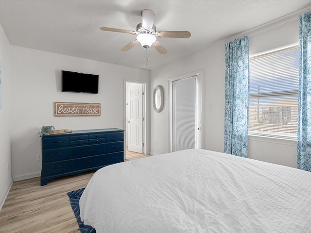127 Howard, Surfside Beach, TX 77541 - bedroom featuring baseboards, a textured ceiling, ceiling fan, and light wood-type flooring
