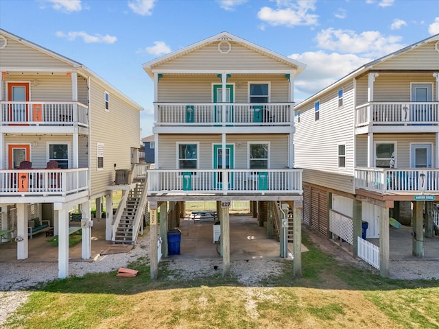 127 Howard, Surfside Beach, TX 77541 - back of property featuring cooling unit, stairway, driveway, a carport, and a yard