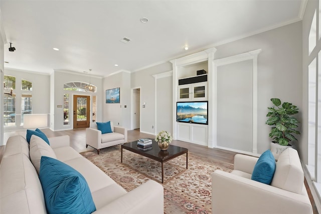 living area featuring recessed lighting, visible vents, baseboards, ornamental molding, and wood finished floors