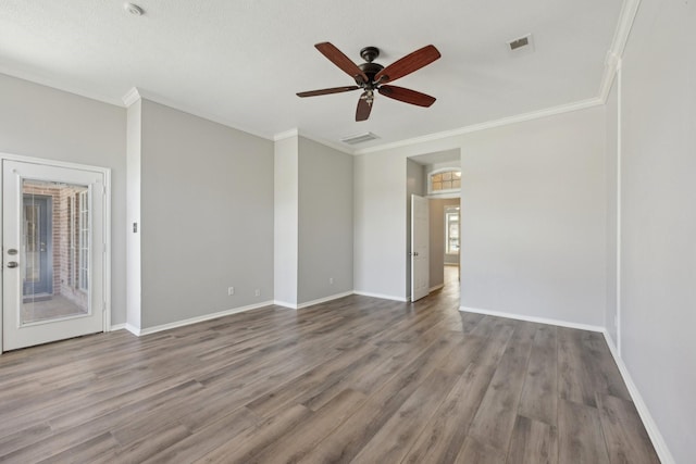 unfurnished room with ornamental molding, visible vents, and ceiling fan