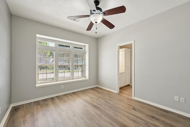 unfurnished bedroom featuring wood finished floors and baseboards