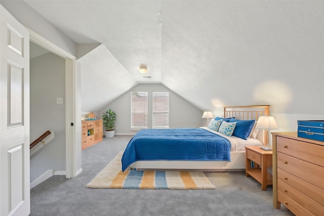 bedroom featuring baseboards, carpet, and lofted ceiling