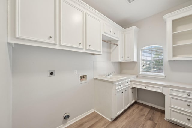 clothes washing area with light wood finished floors, a sink, cabinet space, electric dryer hookup, and hookup for a washing machine