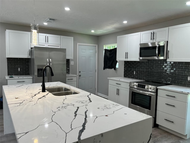 10525 Fairland Dr, Houston, TX 77051 - kitchen featuring a sink, stainless steel appliances, visible vents, and white cabinetry