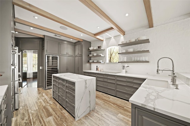 9219 Hummingbird Ln, Missouri City, TX 77459 - kitchen featuring a sink, gray cabinets, a kitchen island, and open shelves