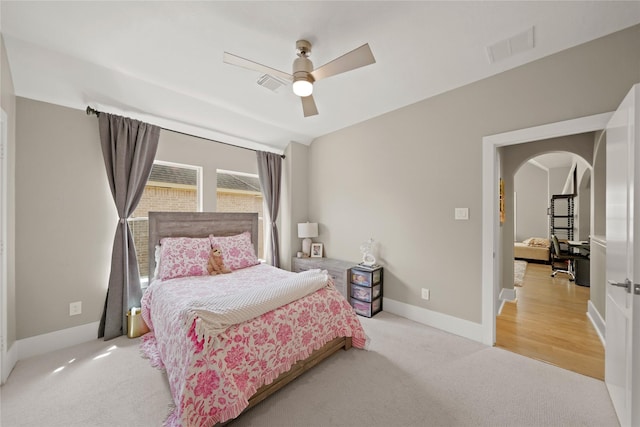 9219 Hummingbird Ln, Missouri City, TX 77459 - carpeted bedroom with ceiling fan, visible vents, arched walkways, and baseboards