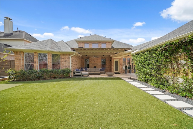 9219 Hummingbird Ln, Missouri City, TX 77459 - back of house featuring an outdoor living space, a patio, a lawn, and brick siding