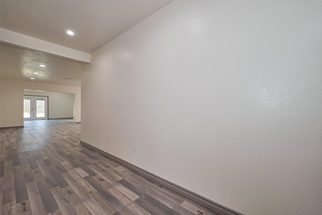 unfurnished room featuring baseboards, dark wood-style flooring, and recessed lighting