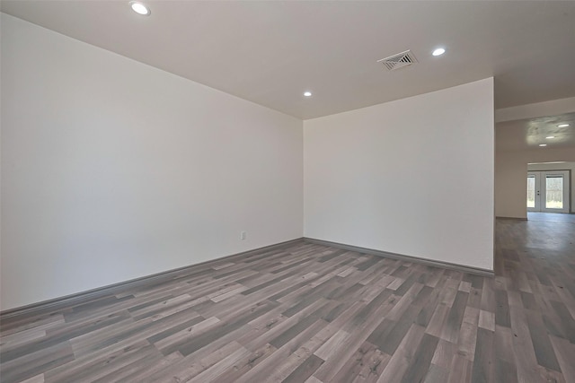 unfurnished room with visible vents, wood finished floors, and recessed lighting