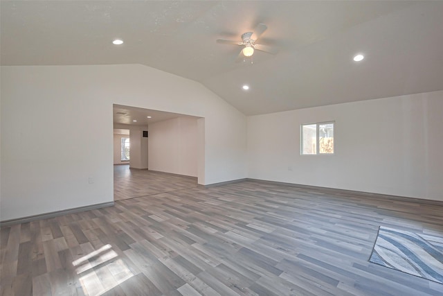 empty room with lofted ceiling, wood finished floors, recessed lighting, and a ceiling fan