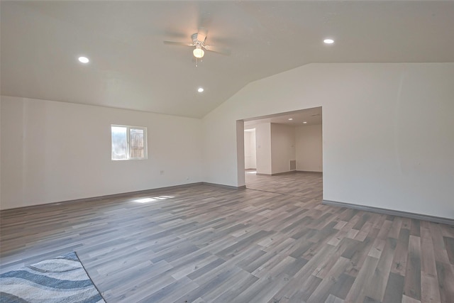 empty room with wood finished floors, recessed lighting, lofted ceiling, and ceiling fan