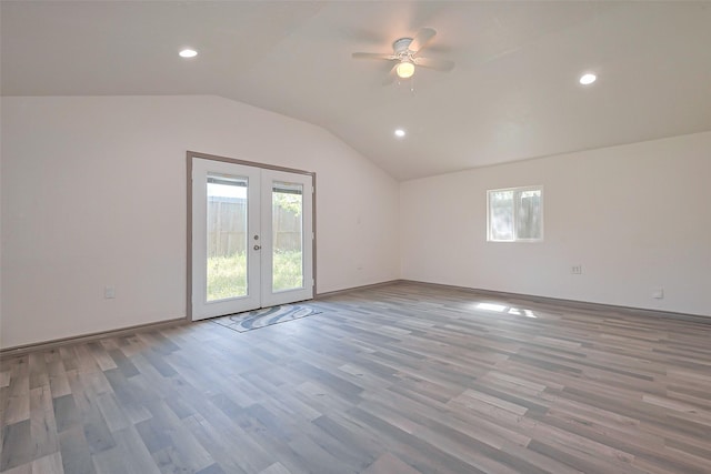 spare room featuring plenty of natural light, lofted ceiling, ceiling fan, and french doors