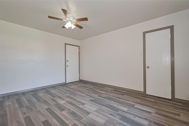empty room with wood finished floors, baseboards, and ceiling fan
