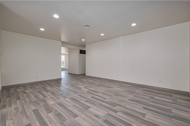 spare room with visible vents, recessed lighting, and wood finished floors