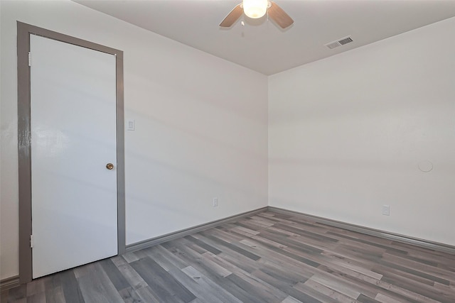 empty room featuring baseboards, visible vents, wood finished floors, and a ceiling fan