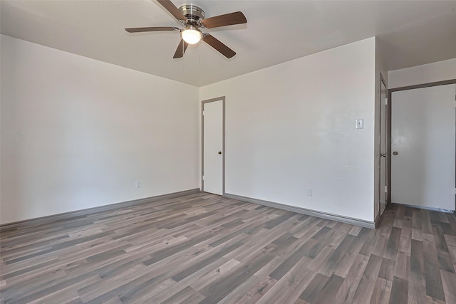 spare room featuring wood finished floors and ceiling fan