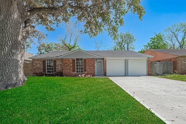 single story home with fence, driveway, a front lawn, brick siding, and a garage
