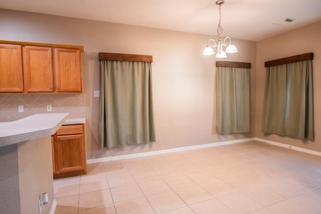 30615 S Sulphur Creek Dr, Magnolia, TX 77355 - interior space featuring a notable chandelier, light countertops, decorative light fixtures, visible vents, and brown cabinets