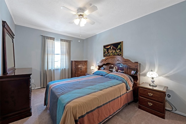 bedroom with a textured ceiling, a ceiling fan, and light carpet