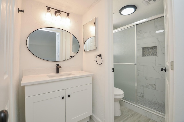 10501 S Dr Unit 300, Houston, TX 77099 - full bathroom with vanity, toilet, visible vents, and a stall shower