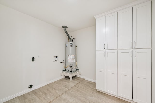 7119 Lumber Jack Dr, Houston, TX 77040 - laundry room featuring electric dryer hookup, cabinet space, water heater, and light wood finished floors