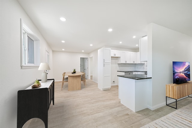 7119 Lumber Jack Dr, Houston, TX 77040 - kitchen with recessed lighting, white cabinets, a peninsula, and baseboards