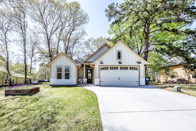 modern farmhouse with board and batten siding, concrete driveway, a front yard, and a garage