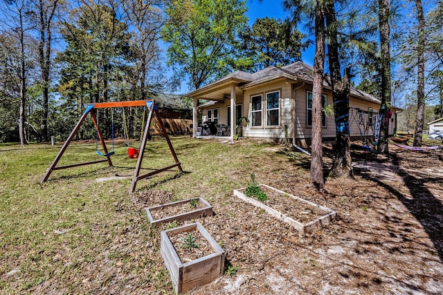 exterior space with a lawn, ceiling fan, and a garden