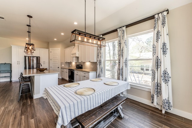 dining space with recessed lighting, baseboards, visible vents, and dark wood-type flooring