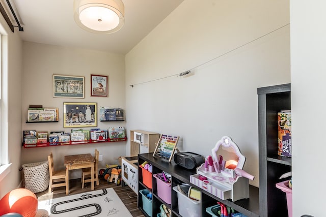 recreation room with dark wood finished floors