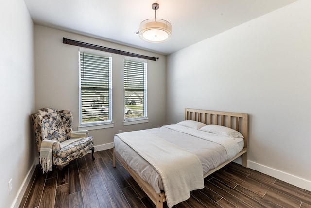 bedroom featuring dark wood-type flooring and baseboards
