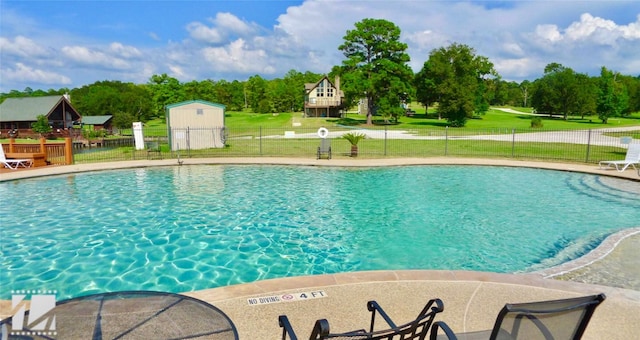 pool with a lawn and fence