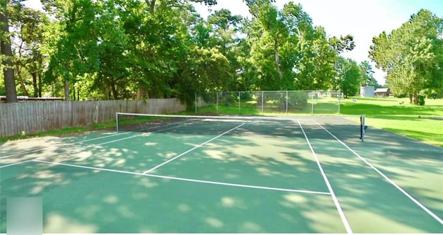 view of tennis court featuring fence
