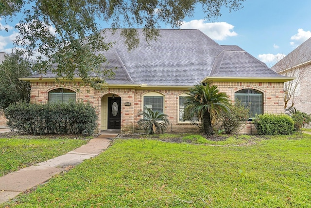 14959 Royal Birkdale St, Houston, TX 77095 - view of front facade with brick siding, roof with shingles, and a front yard