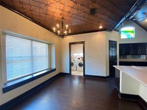 14959 Royal Birkdale St, Houston, TX 77095 - interior space with baseboards, a notable chandelier, and dark cabinets
