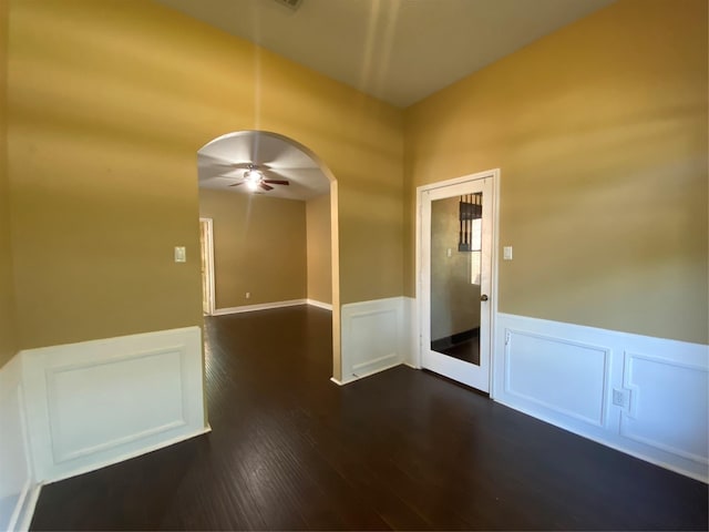 14959 Royal Birkdale St, Houston, TX 77095 - spare room with a ceiling fan, arched walkways, dark wood-style floors, a decorative wall, and wainscoting