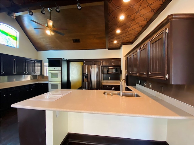 14959 Royal Birkdale St, Houston, TX 77095 - kitchen with light countertops, white appliances, ceiling fan, dark brown cabinetry, and a sink