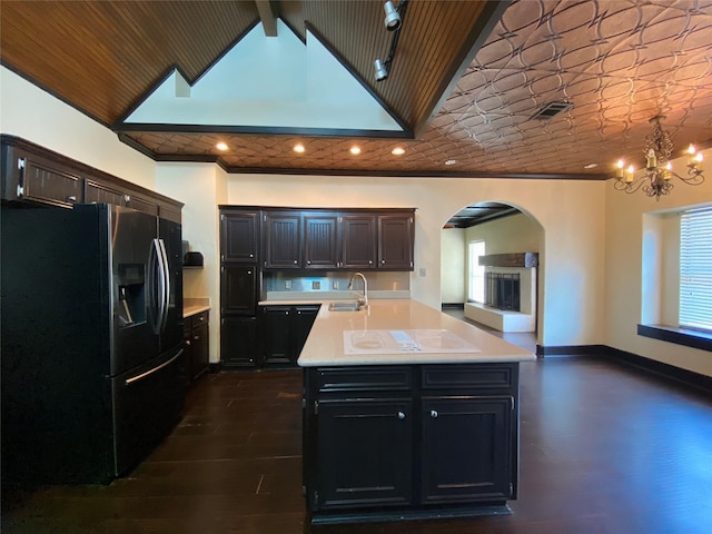 14959 Royal Birkdale St, Houston, TX 77095 - kitchen with light countertops, arched walkways, a sink, fridge with ice dispenser, and an inviting chandelier