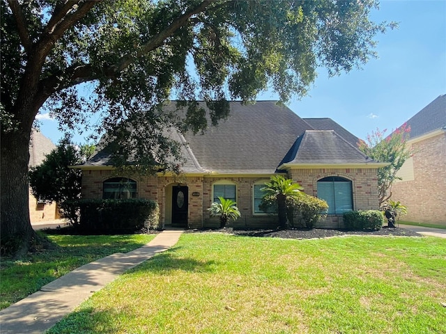 14959 Royal Birkdale St, Houston, TX 77095 - view of front of home with brick siding, a shingled roof, and a front lawn