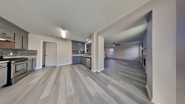 kitchen featuring decorative backsplash, ceiling fan, visible vents, gray cabinetry, and appliances with stainless steel finishes