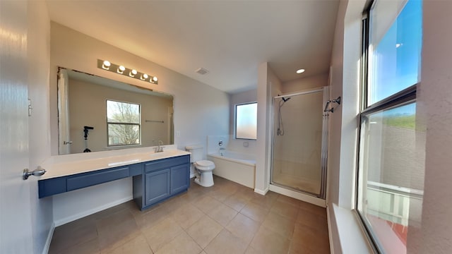 full bathroom with a shower stall, toilet, a bath, vanity, and tile patterned flooring